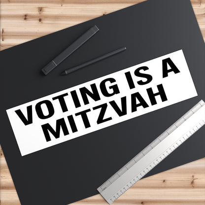 Poster with 'Voting is a Mitzvah' text on a black background with a pen and ruler.