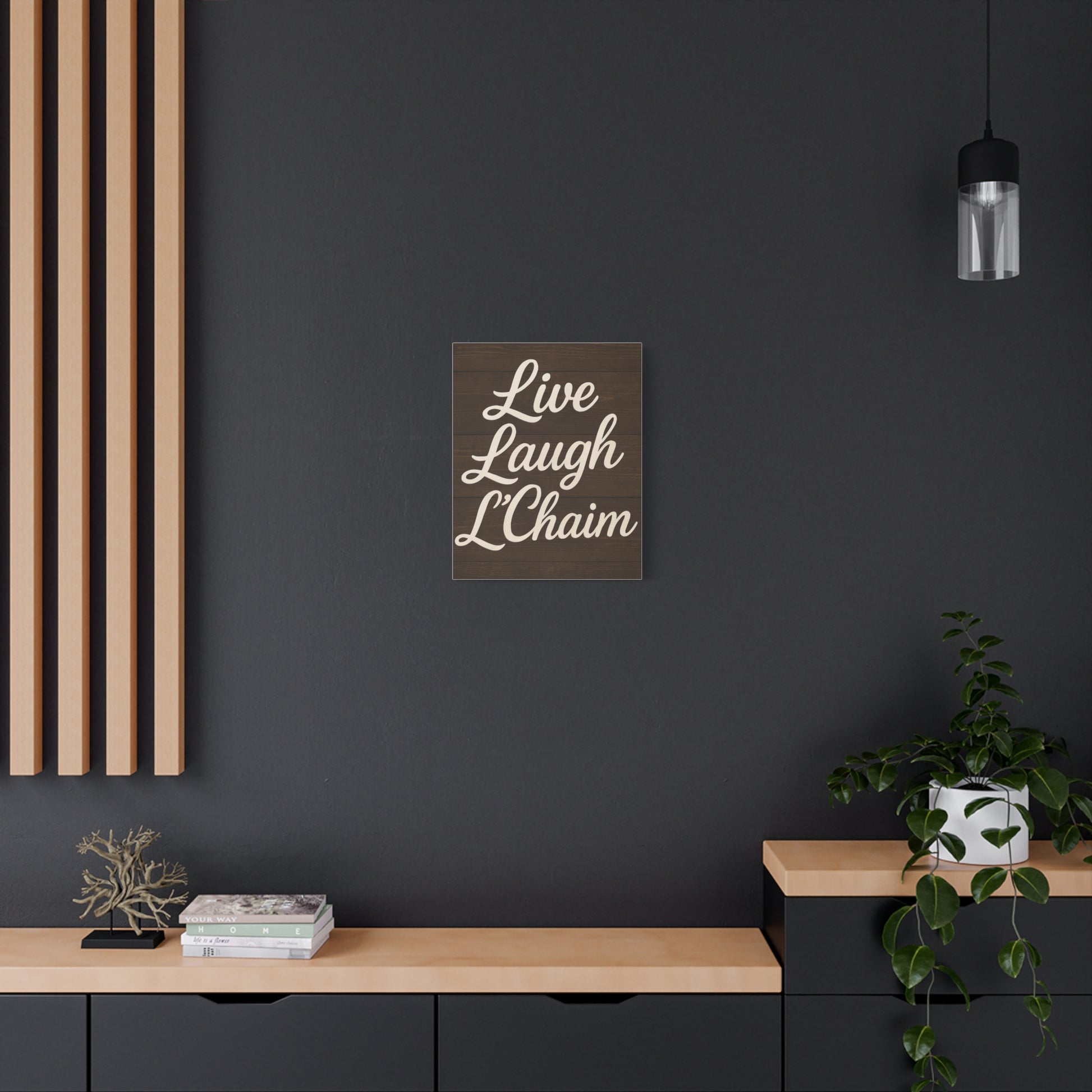 Modern interior with a 'Live Laugh L'Chaim' print on a dark wall.