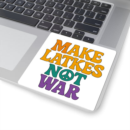 Sticker with 'Make Latkes Not War' text on a laptop keyboard