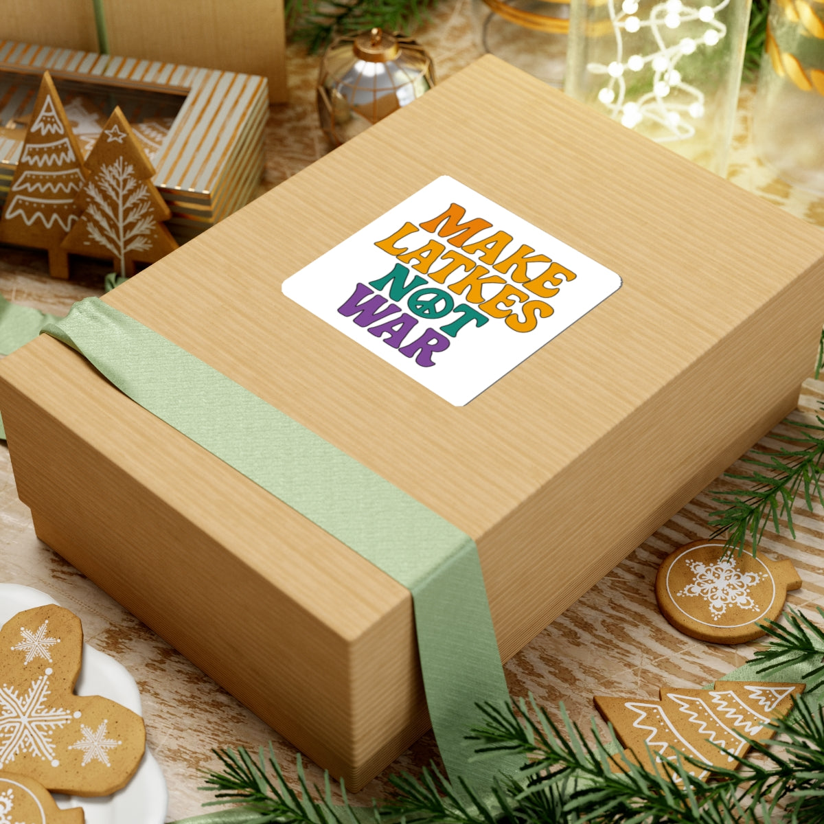 Wooden gift box with a colorful 'make latkes not war' sticker on a festive background with cookies and lights 