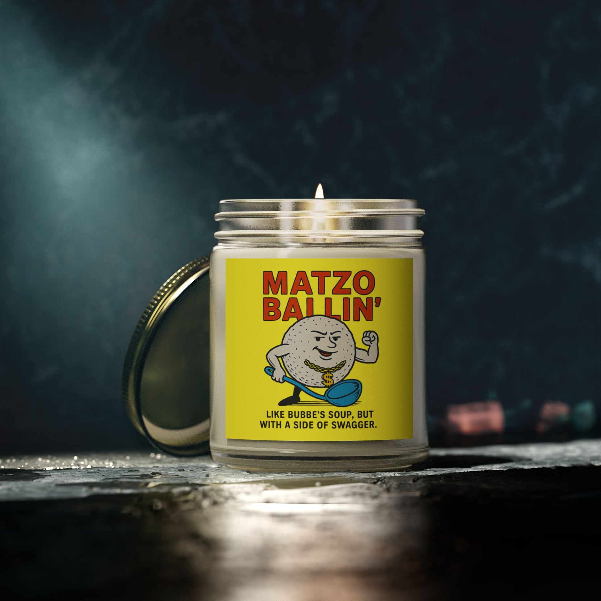 Candle with a 'Matzo Ballin'' label on a dark background