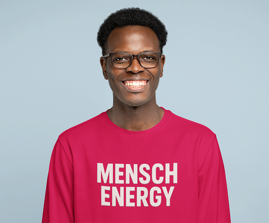 Man wearing a pink shirt with 'MENSCH ENERGY' text against a light blue background