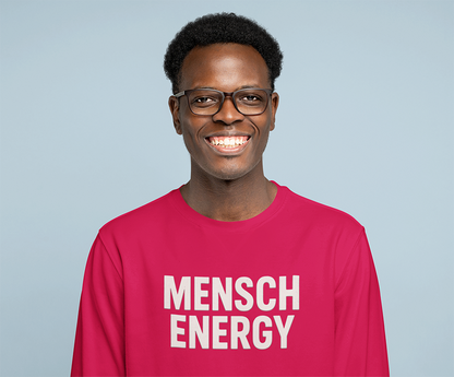 Man wearing a pink shirt with 'MENSCH ENERGY' text against a light blue background