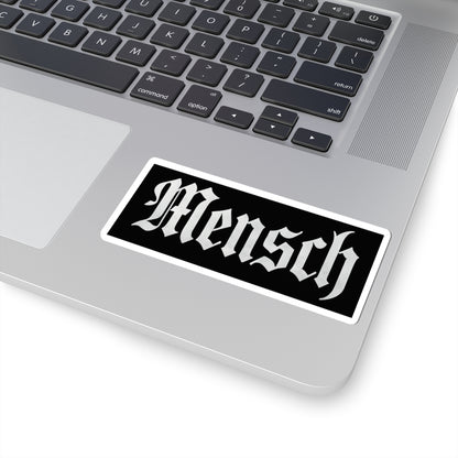 Laptop with a 'Mensch' sticker on the palm rest area