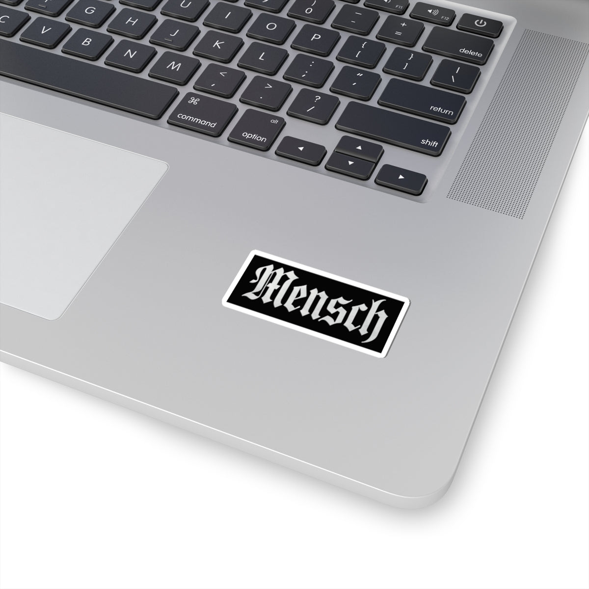 Laptop with a 'Mensch' sticker on the palm rest area