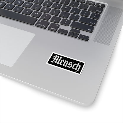 Laptop with a 'Mensch' sticker on the palm rest area
