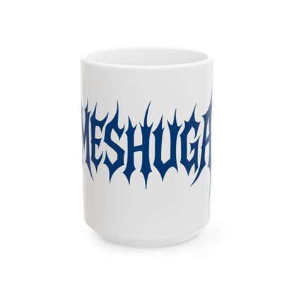 White mug with 'meshuga' in blue text on a white background