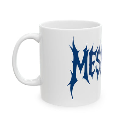 White mug with blue 'meshuga' design on a white background