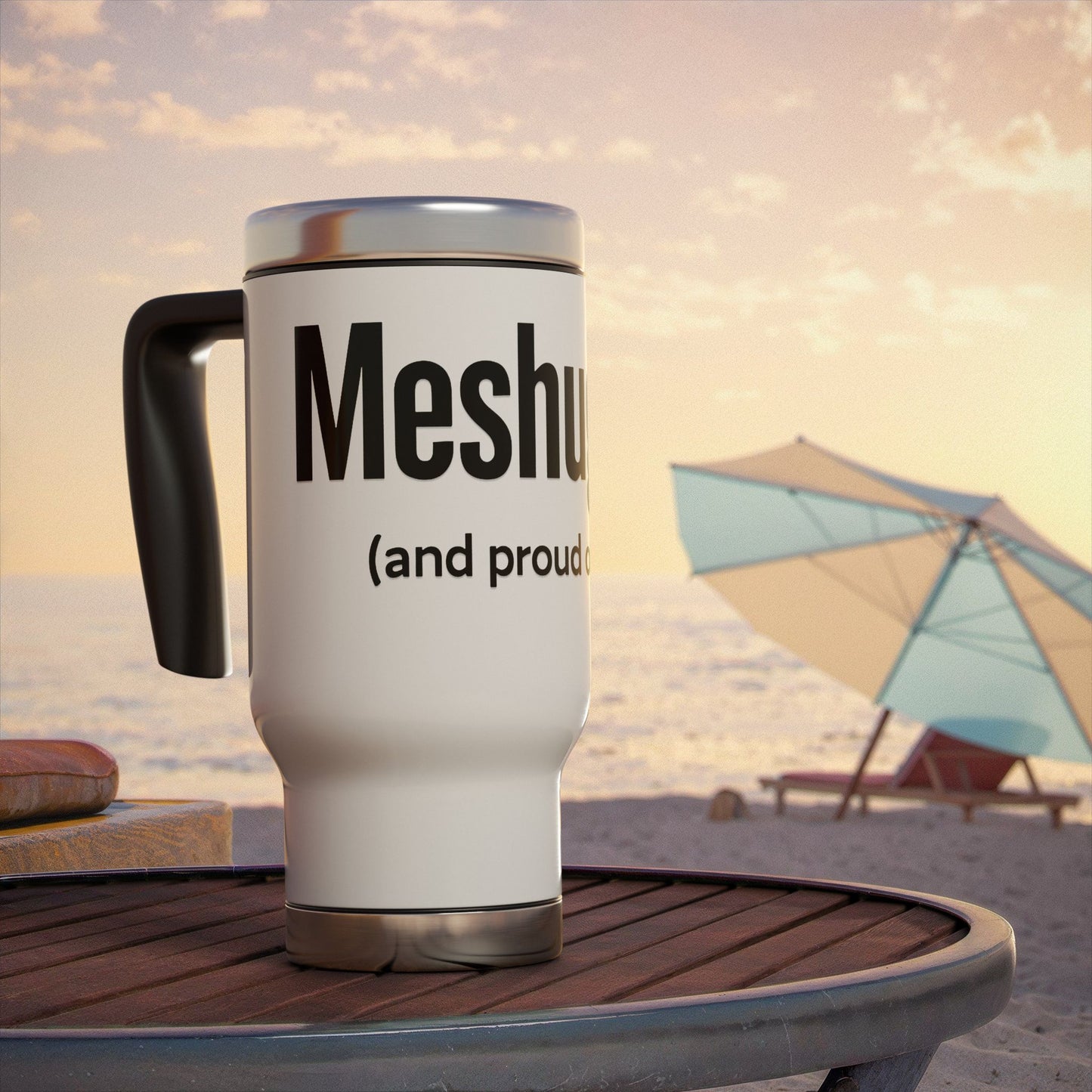 Travel mug with 'Meshugga' (and proud)' text on a beach setting