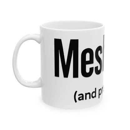 White mug with black text 'meshugga' on a white background