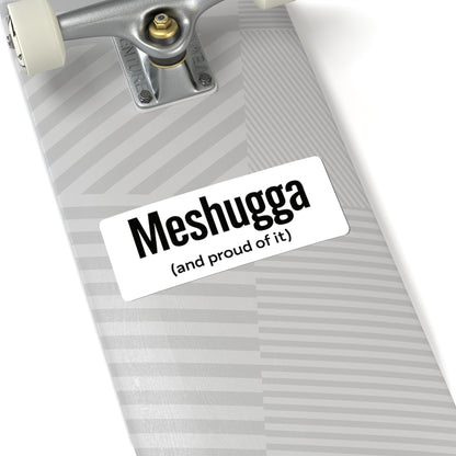 Skateboard with a 'Meshugga (and proud of it)' sticker on a white background