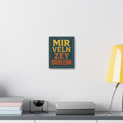 Framed artwork with text on a wall above a desk with books and a lamp.