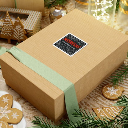 Gift box with a decorative label on a festive background with cookies and greenery