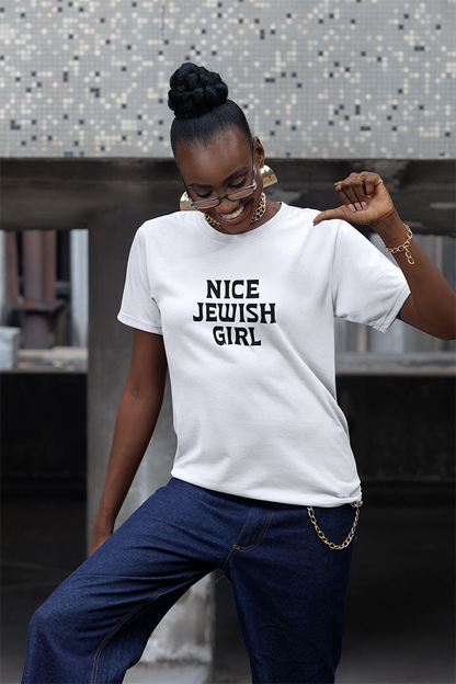 Woman wearing a white t-shirt with 'NICE JEWISH GIRL' text, standing outdoors.
