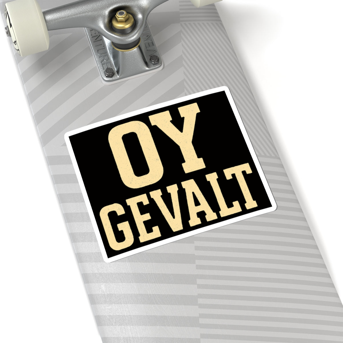 Skateboard with 'OY GEVALT' sticker on a white background