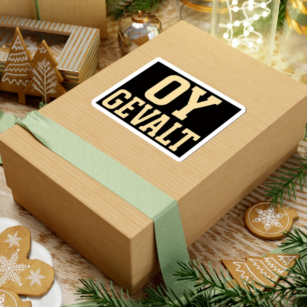 Wooden gift box with a 'oy gevalt' sticker on a festive background with cookies and greenery.