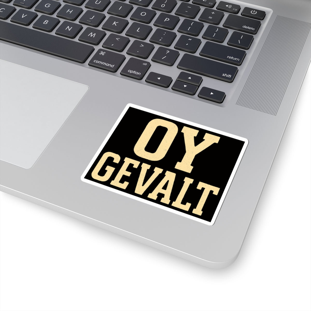 Laptop with a 'OY GEVALT' sticker on the palm rest area