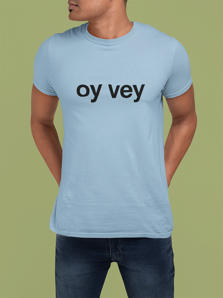 Person wearing a light blue t-shirt with 'oy vey' text on a green background