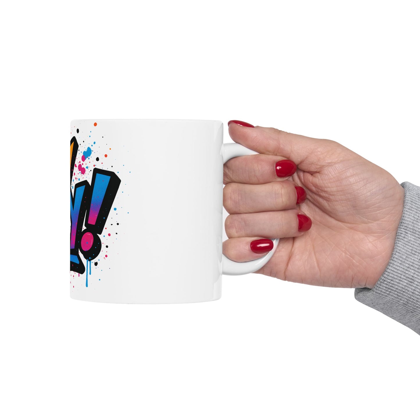 Hand holding a white mug with colorful 'Oy Vey' design on a white background