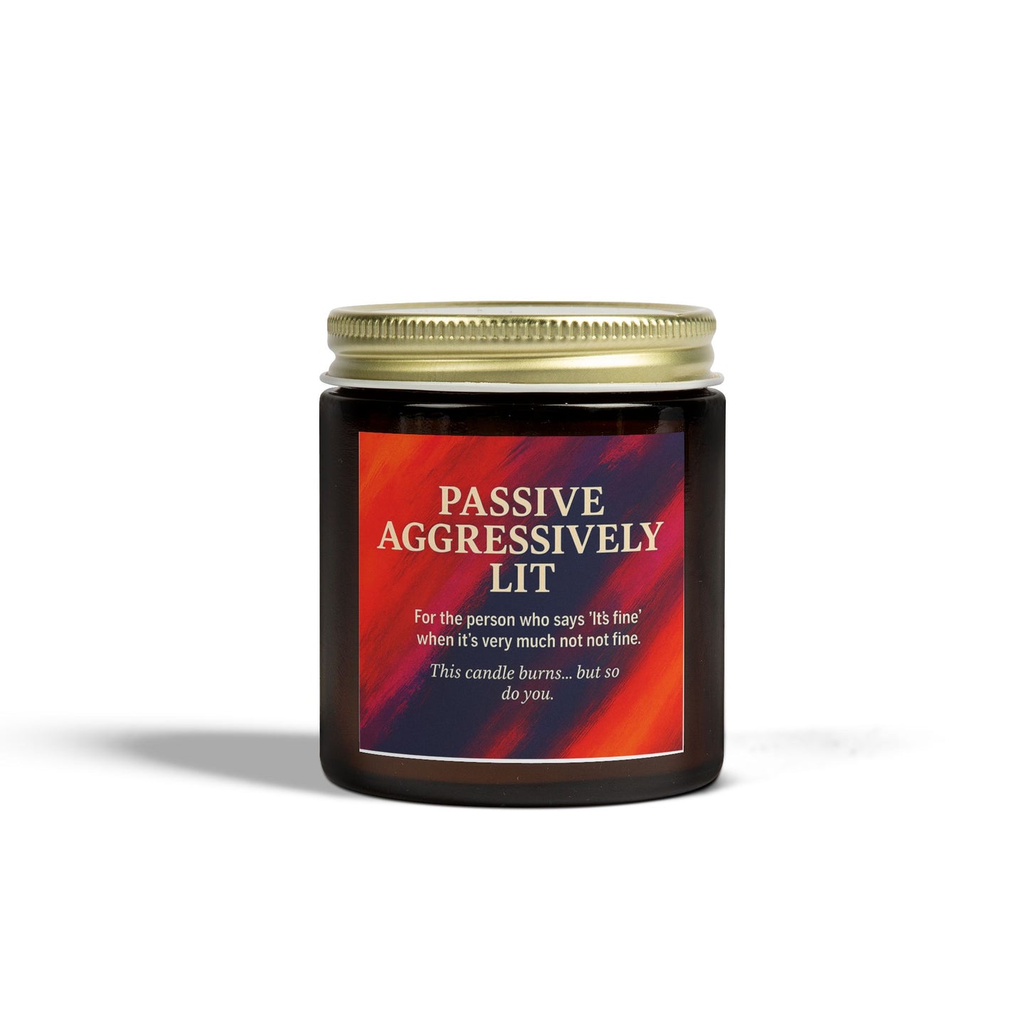 Candle jar with a red label and gold lid on a white background