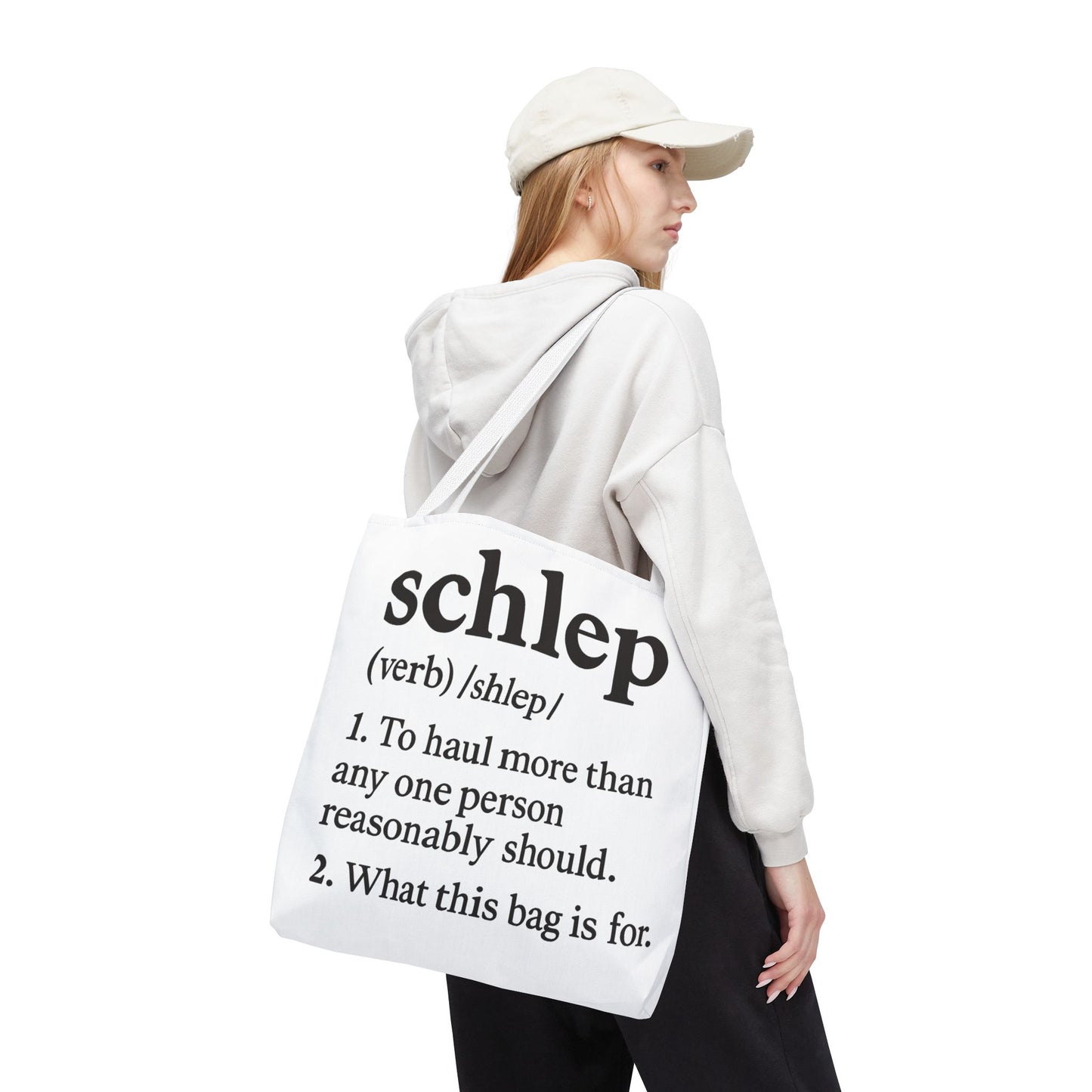 Person wearing a white hoodie and holding a tote bag with text on a white background