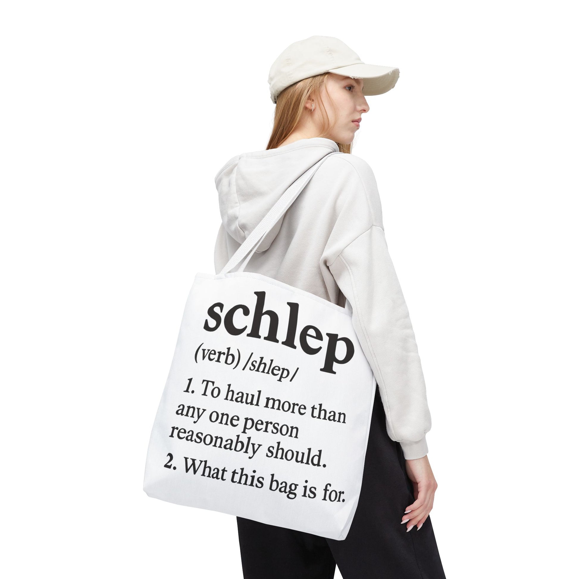 Person wearing a white hoodie and holding a tote bag with text on a white background
