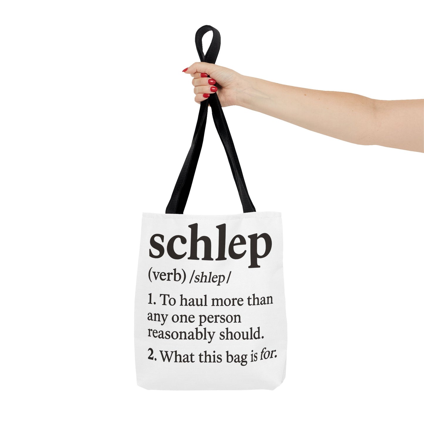 Tote bag with definition of 'schlep' held by a hand on a white background
