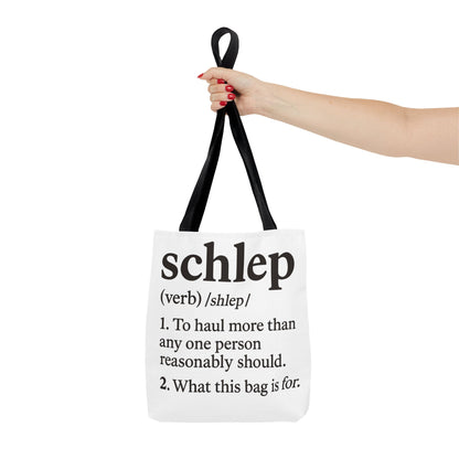 Tote bag with definition of 'schlep' held by a hand on a white background