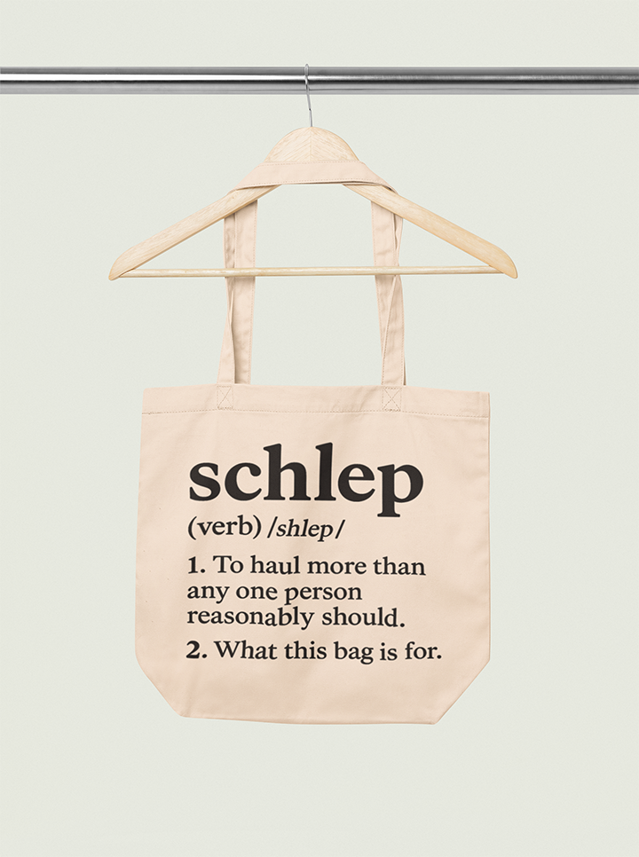 Tote bag with text on a hanger against a white background