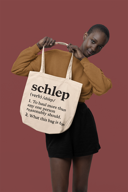 Person holding a tote bag with text on a red background
