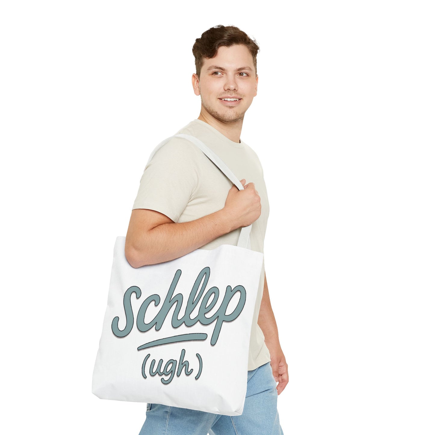 Man holding a tote bag with 'Schlep (ugh)' text on a white background