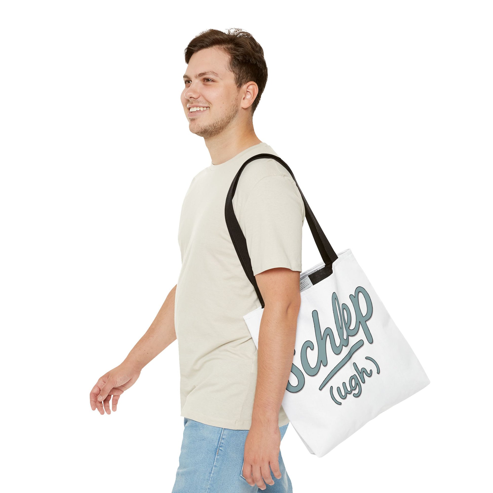 Man carrying a white tote bag with text on a plain background