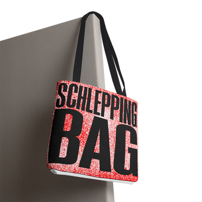 Tote bag with 'SCHLEPPING BAG' text on a gray background