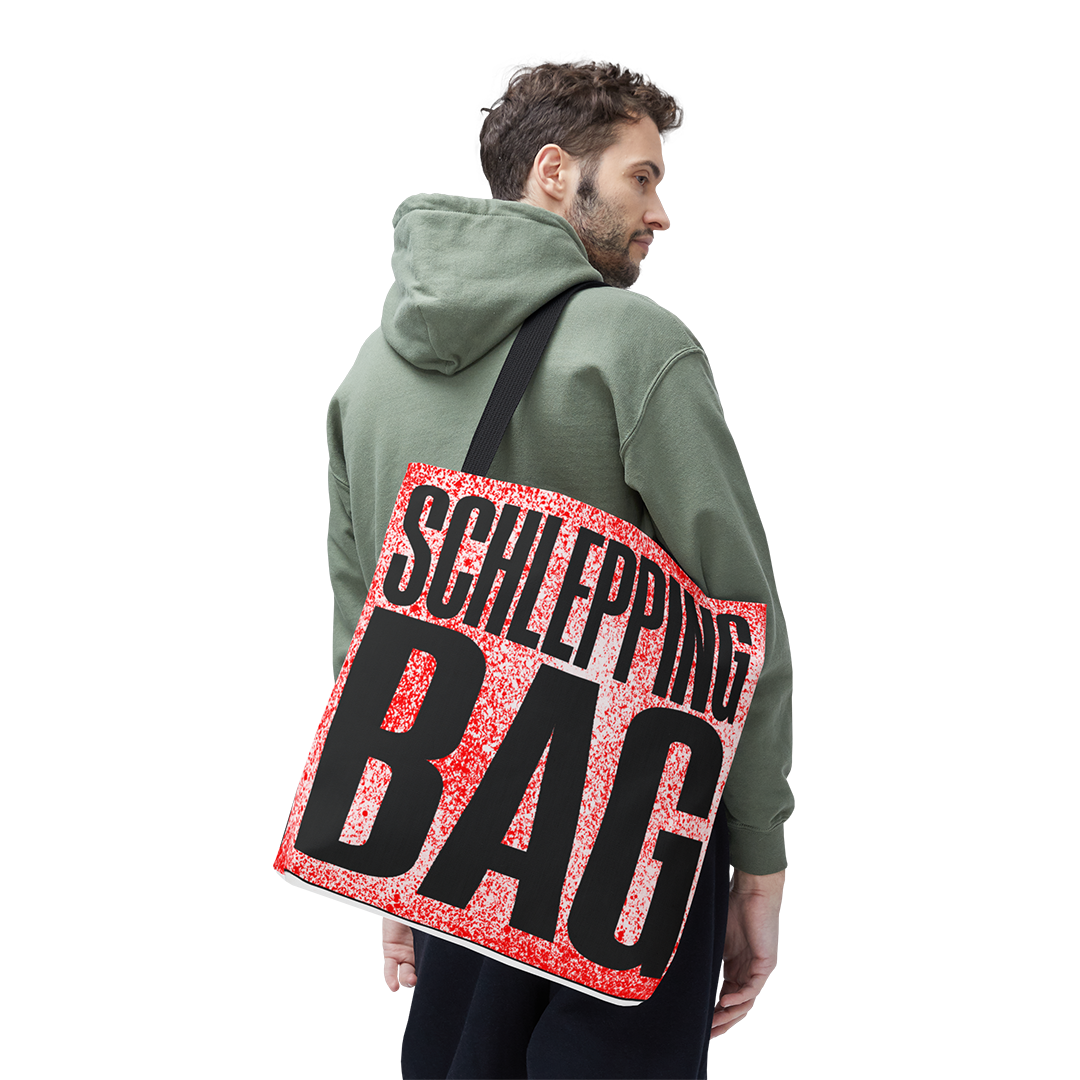 Man wearing a green hoodie with a red and black 'SCHLEPPING BAG' bag over his shoulder on a white background