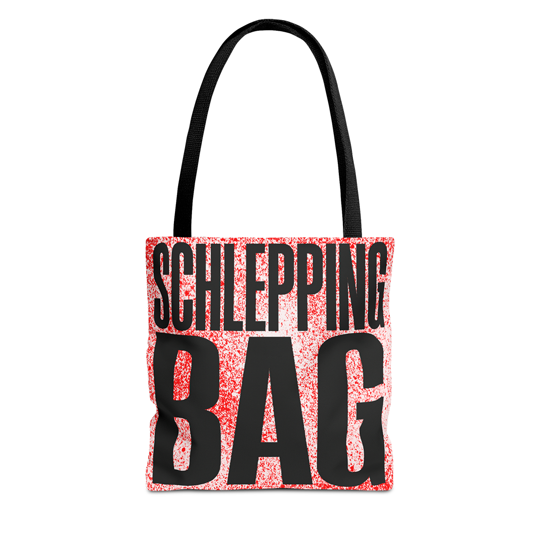 Tote bag with 'SCHLEPPING BAG' text on a red and black patterned background