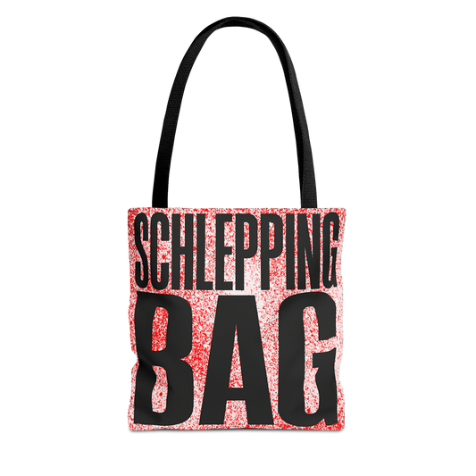 Tote bag with 'SCHLEPPING BAG' text on a red and black patterned background