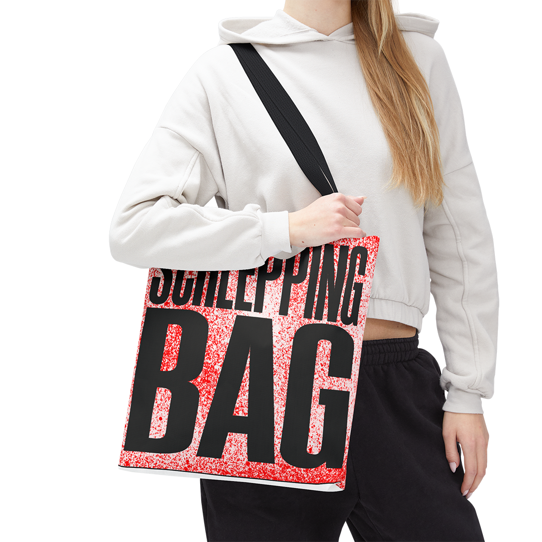 Person holding a tote bag with 'Schlepping Bag' text on a white background