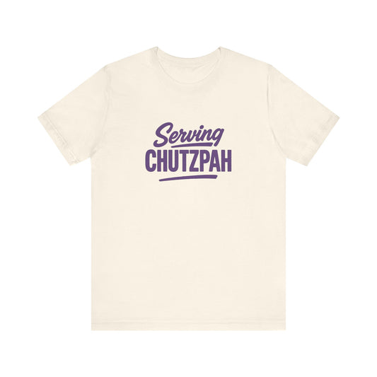 Natural t-shirt with 'Serving Chutzpah' text in purple on a white background