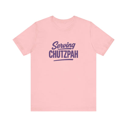 Pink t-shirt with 'Serving Chutzpah' text on a white background
