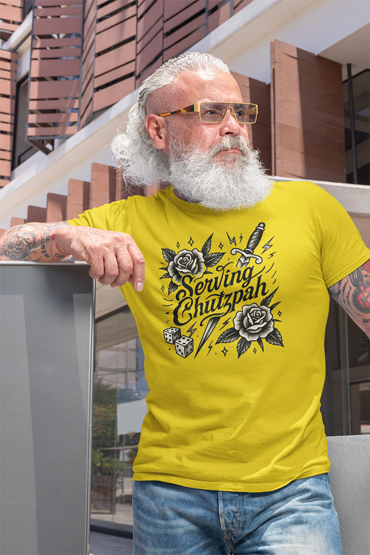 Man wearing a yellow t-shirt with a graphic design, standing outdoors.