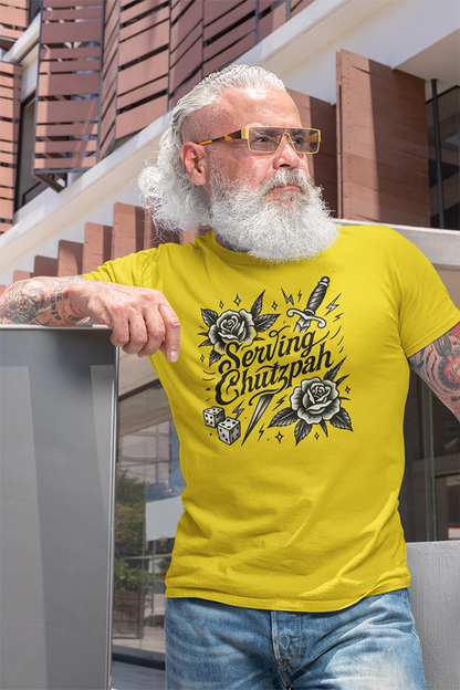 Man wearing a yellow t-shirt with a graphic design, standing outdoors.