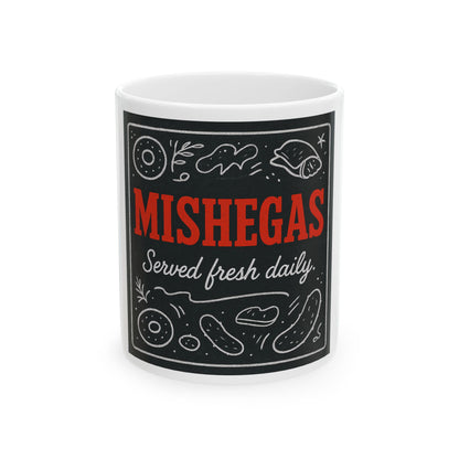White mug with black label featuring the text 'Mishegas Served fresh daily' on a white background