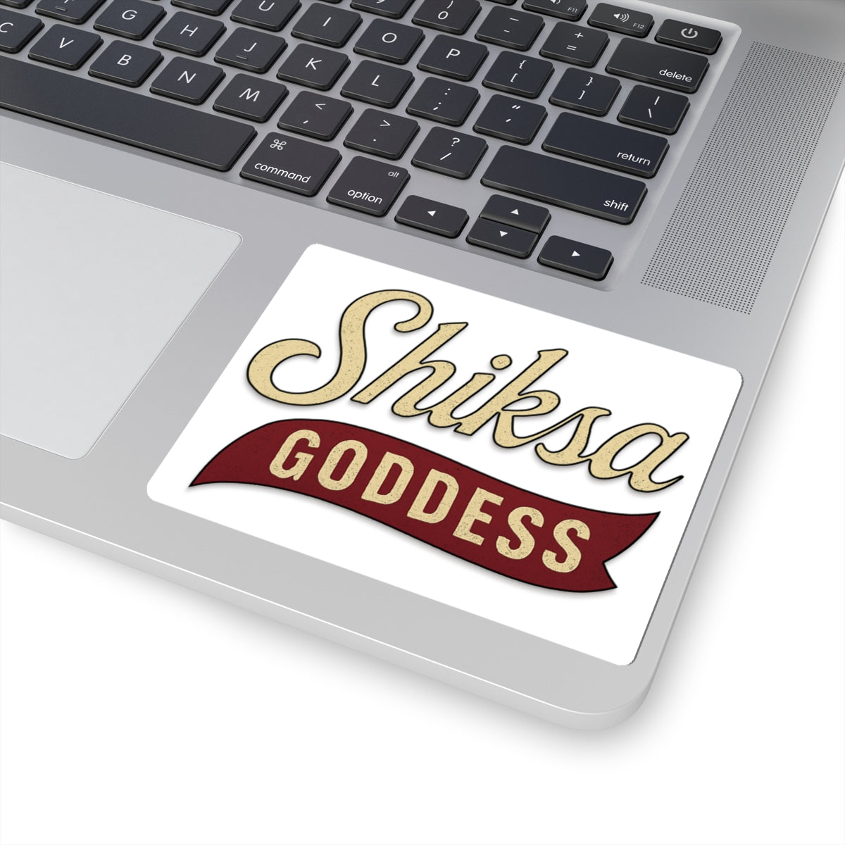Laptop with a sticker reading 'Shiksa Goddess' on the palm rest area.