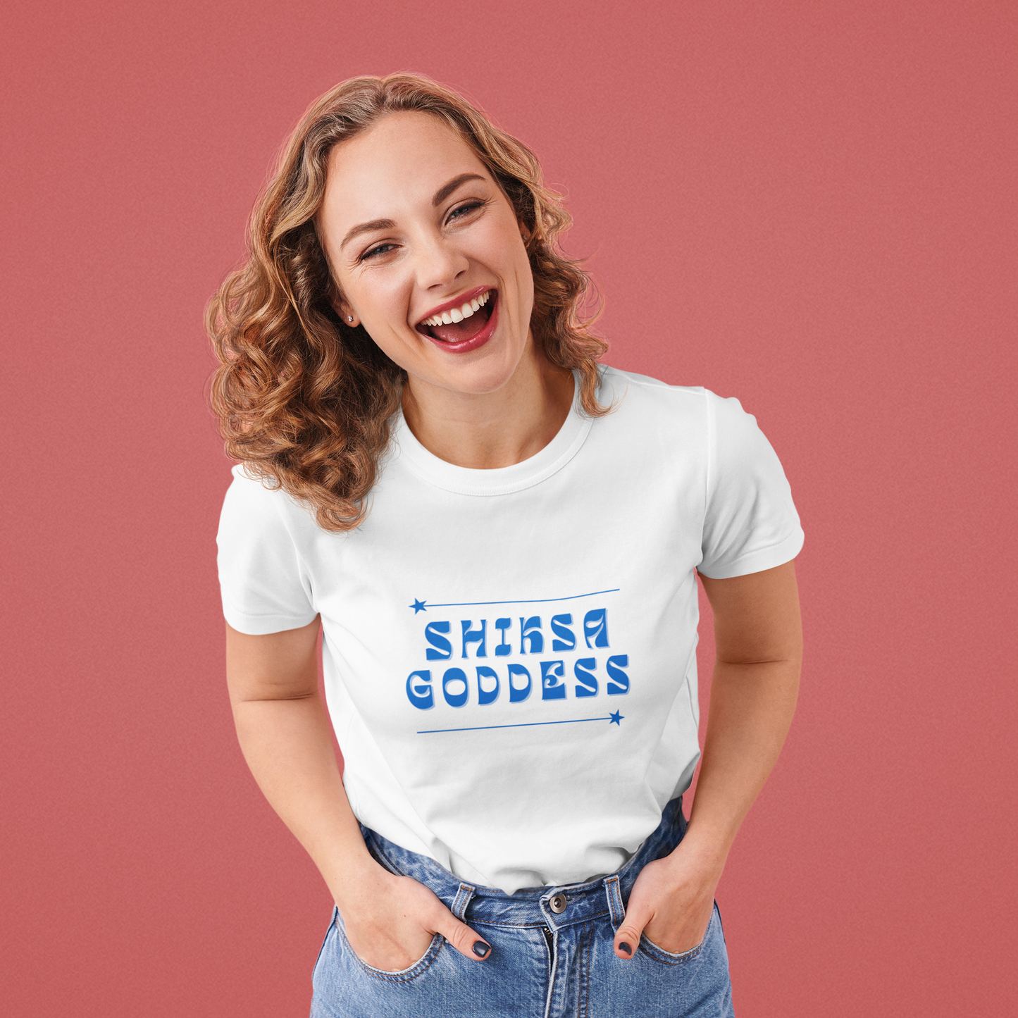 Woman wearing a white t-shirt with 'SHIKSA GODDESS' text on a red background