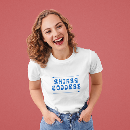 Woman wearing a white t-shirt with 'SHIKSA GODDESS' text on a red background
