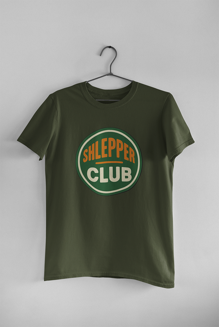 Green t-shirt with 'Shlepper Club' logo on a hanger against a white background