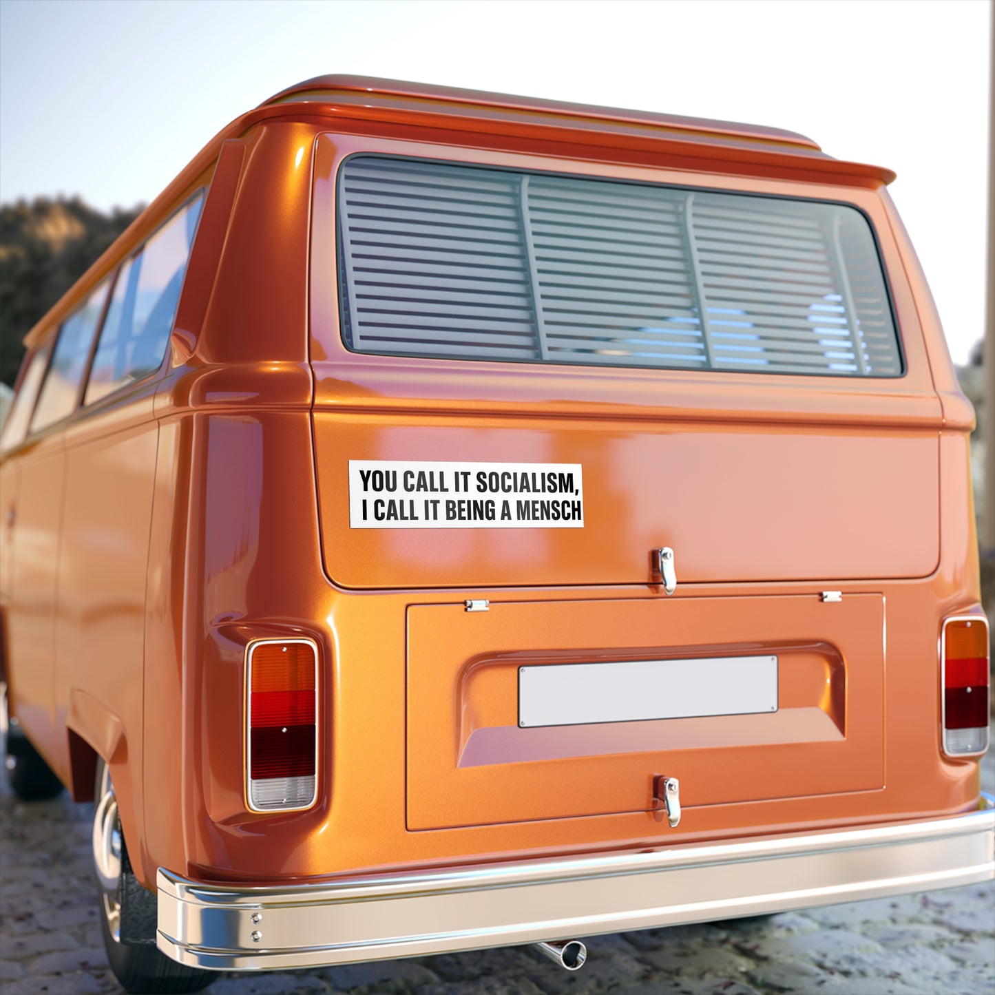 Orange van with a humorous sticker on the back