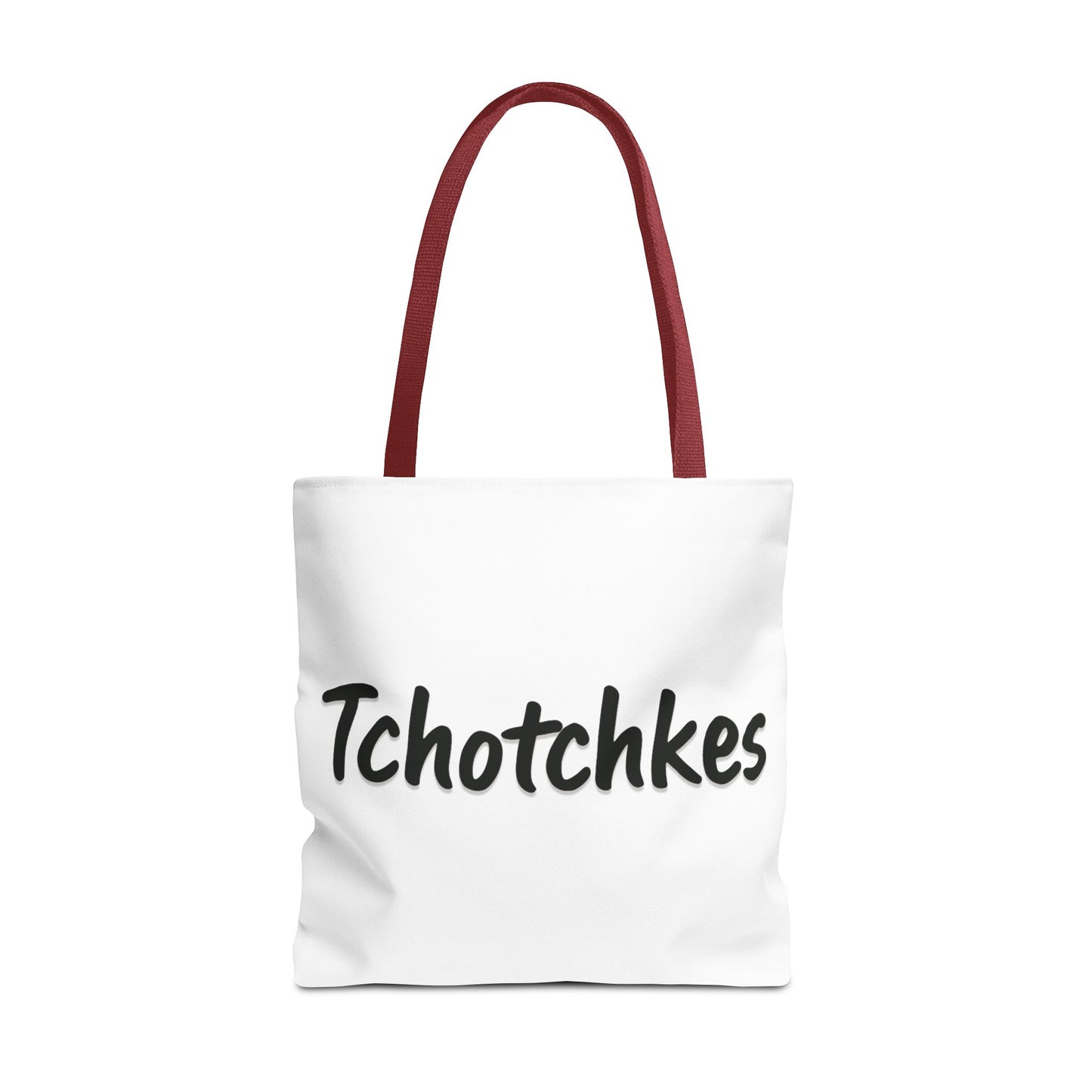 White tote bag with red handles and 'Tchotchkes' text on a white background
