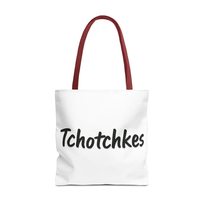 White tote bag with red handles and 'Tchotchkes' text on a white background