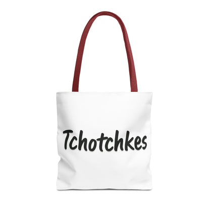 White tote bag with red handles and 'Tchotchkes' text on a white background